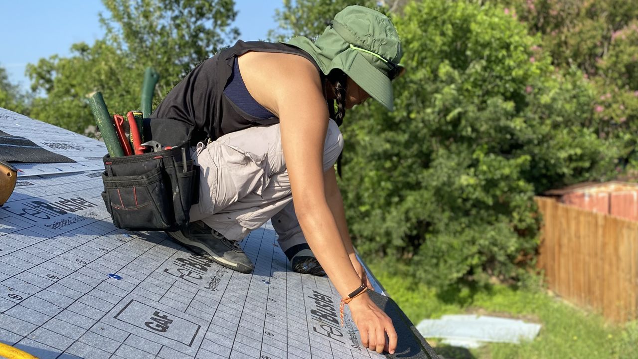 Zeyla Alcantara of New Braunfels-based Roofer Chicks works on a roof in late May in Texas.