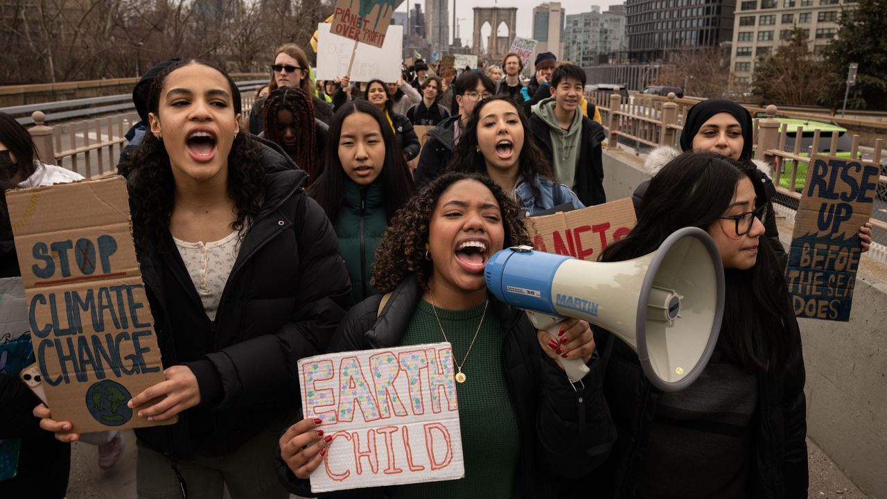 Demonstrators march across the Brooklyn Bridge during a Global Climate Strike in New York, US, on Friday, March 3, 2023. The theme of the strike is 