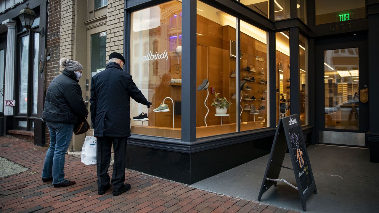 Pedestrians look at sneakers displayed at an Allbirds store in the Georgetown neighborhood of Washington, D.C., U.S., on Tuesday, Feb. 16, 2021.