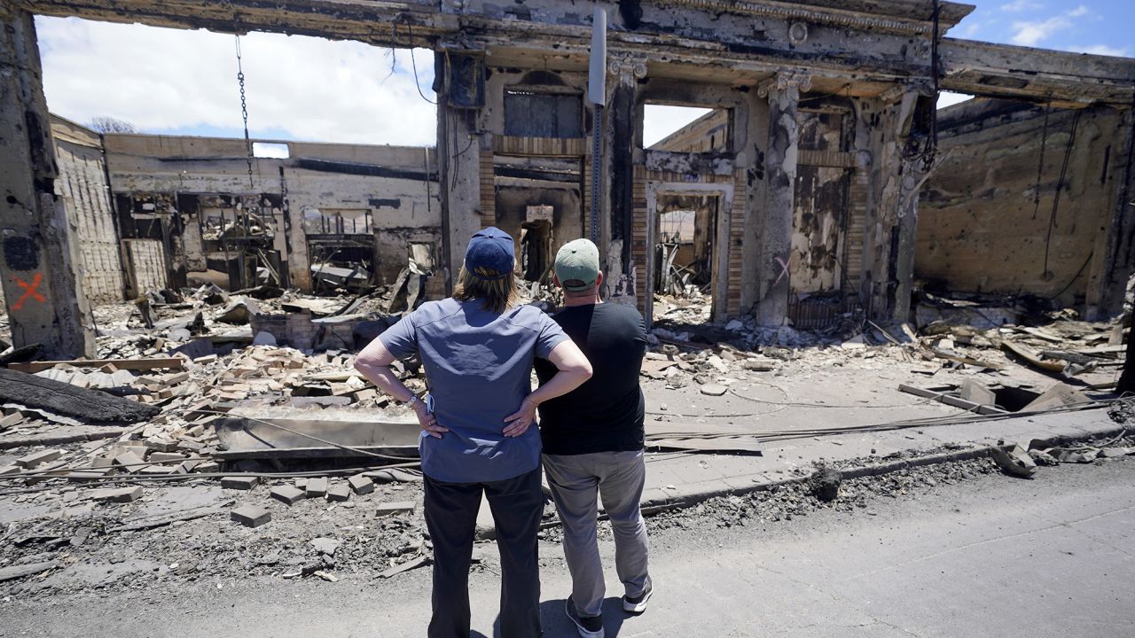 Governor of Hawaii Josh Green, right, and FEMA Administrator Deanne Criswell look at a destroyed building along Front Street during a tour of wildfire damage on Saturday, Aug. 12, 2023, in Lahaina, Hawaii. 