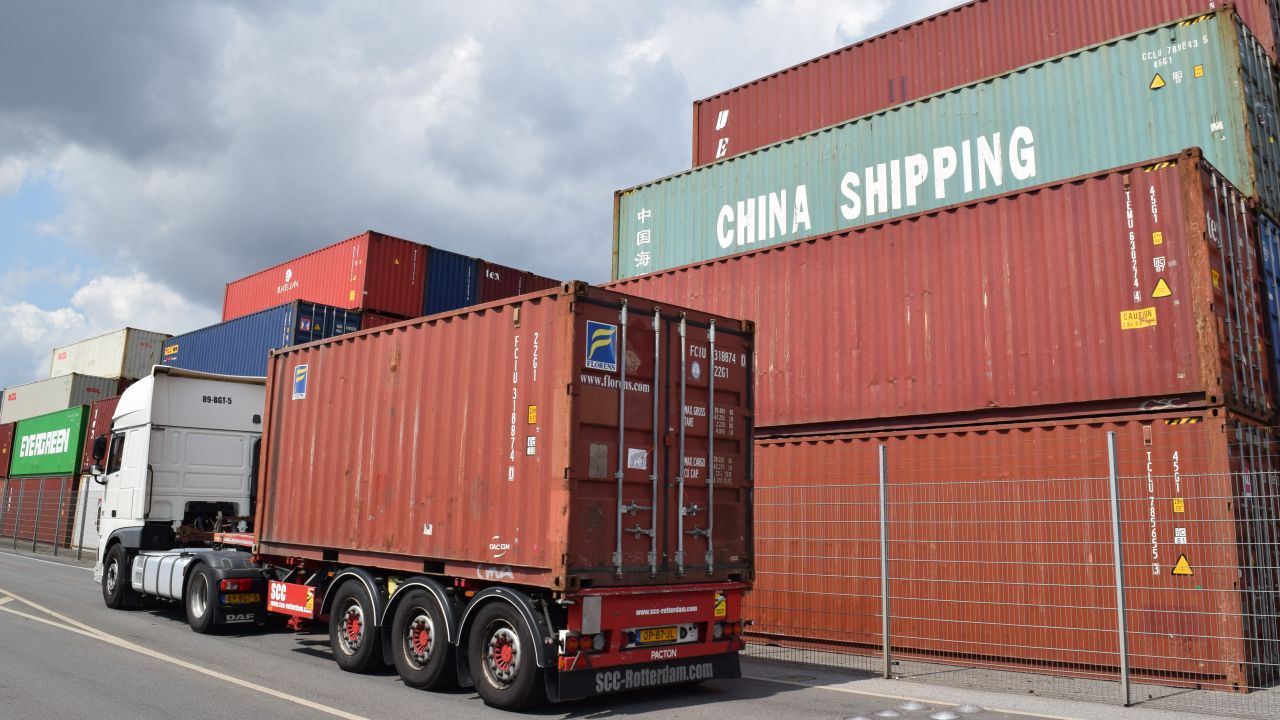 A truck drives past containers piled up at the German port in Duisburg in June. 