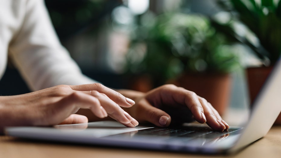 hands typing on computer