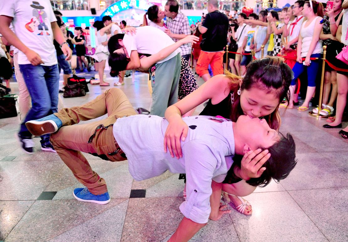 Couples attend a kissing contest during the traditional Qixi festival in Shenyang, northeast China's Liaoning province, on August 13, 2013.