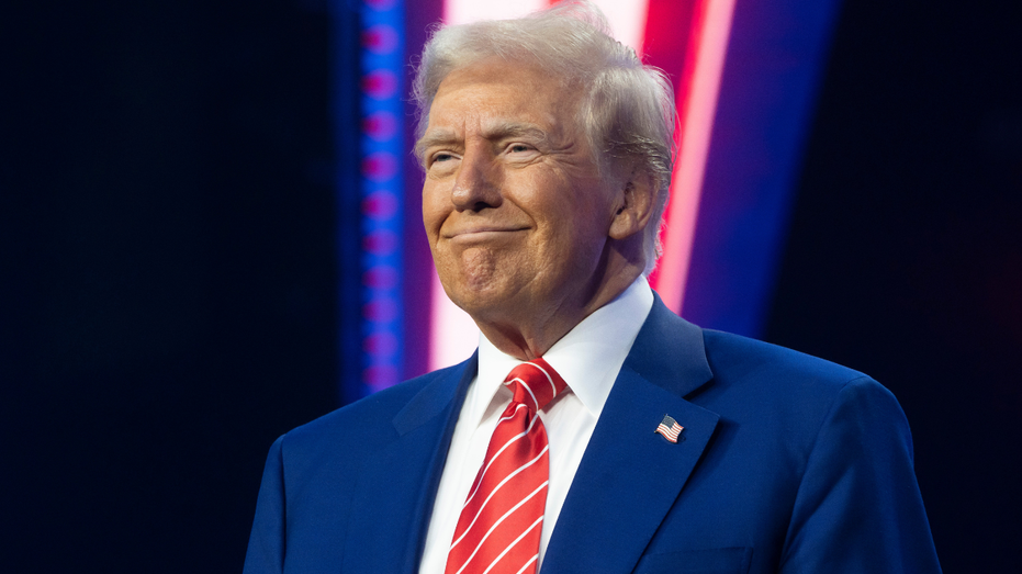 Then-U.S. President-elect Donald Trump smiling during a Turning Point USA event in Phoenix, Arizona.