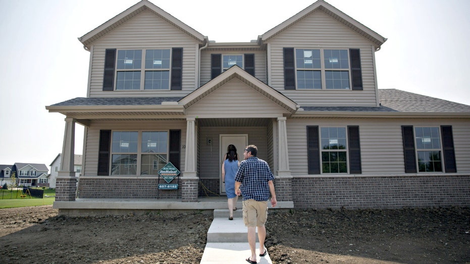 A couple tours a home.